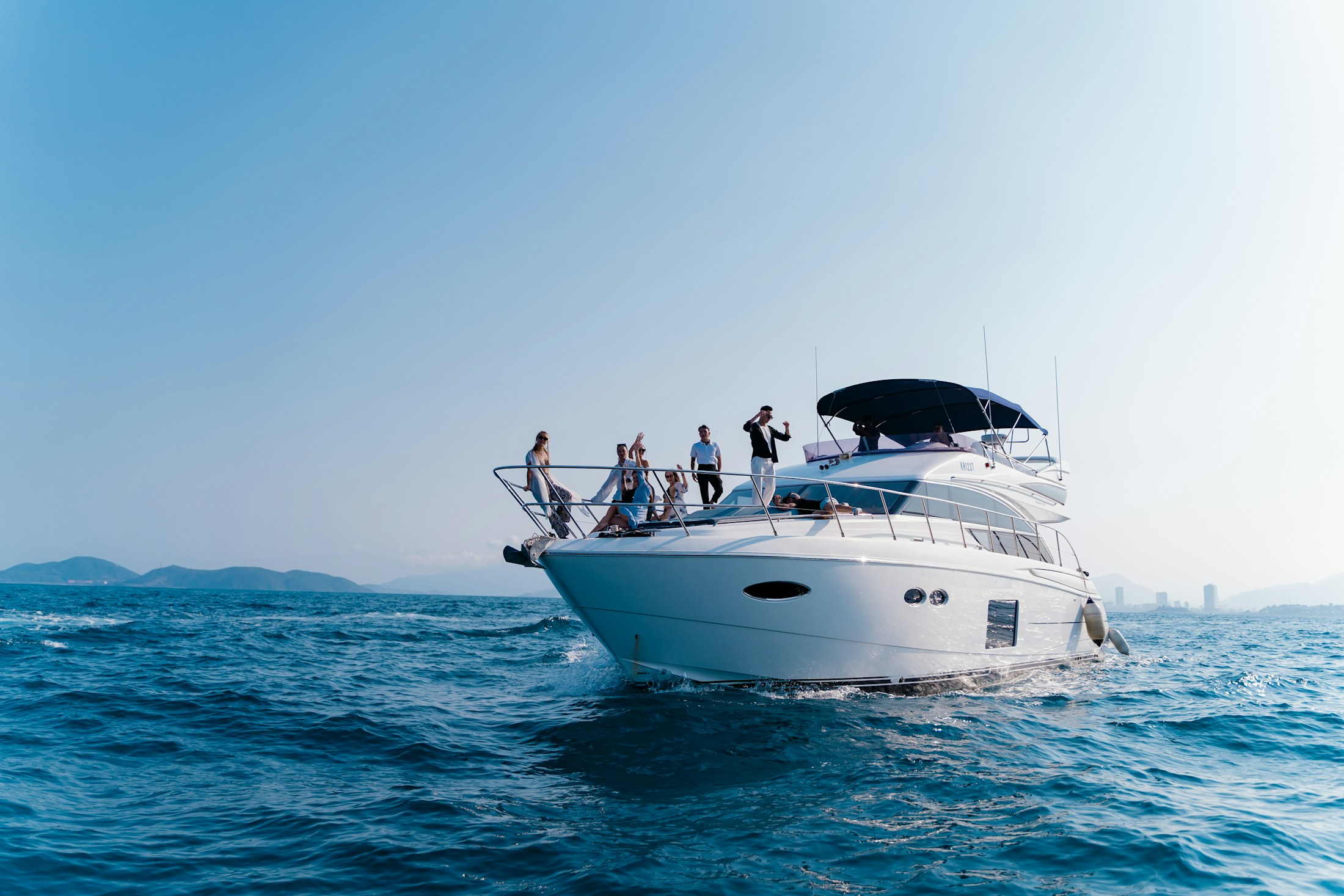 Guests relaxing aboard a motor yacht underway