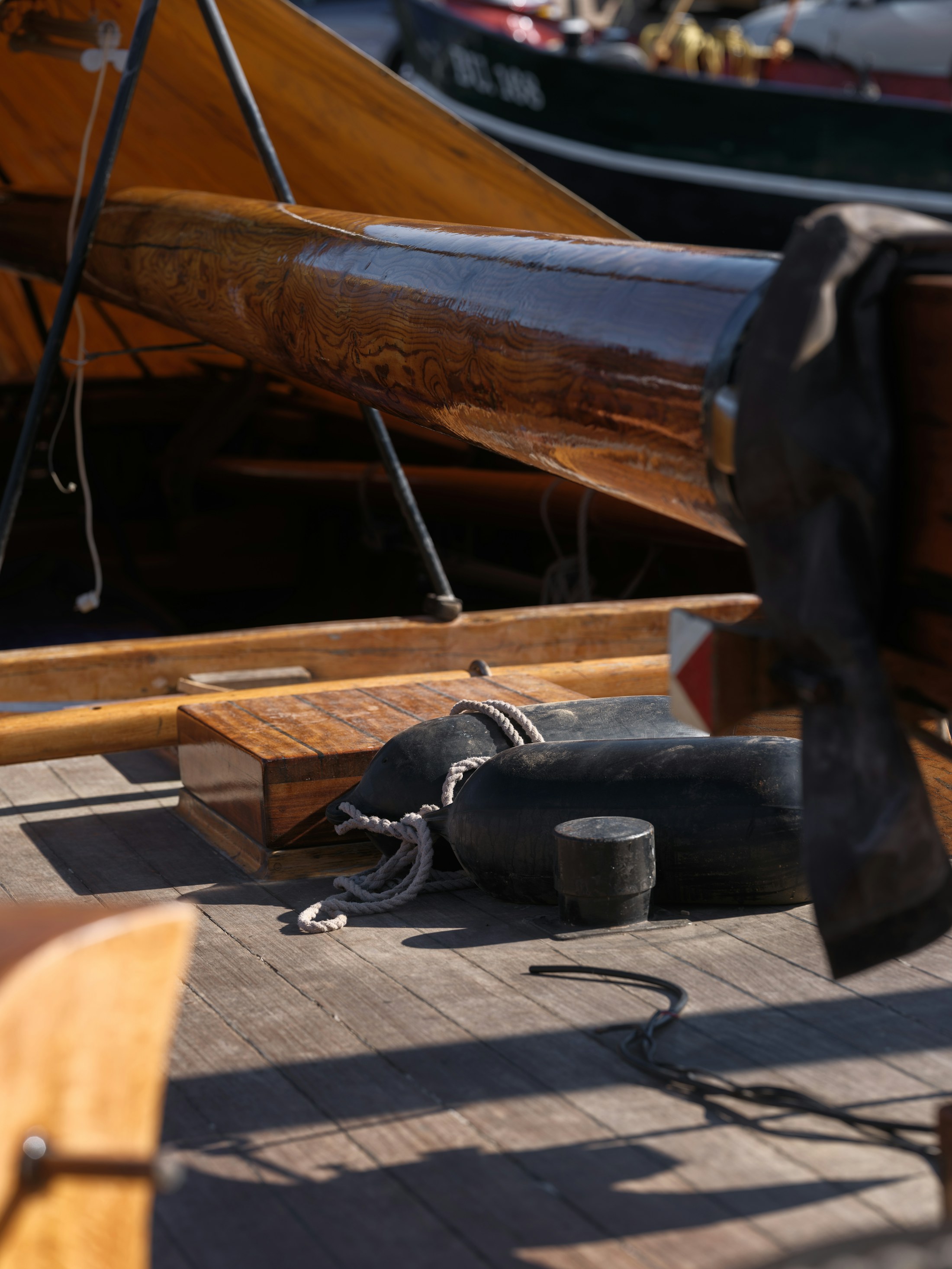 Mooring lines secured to cleats on a wooden yacht deck